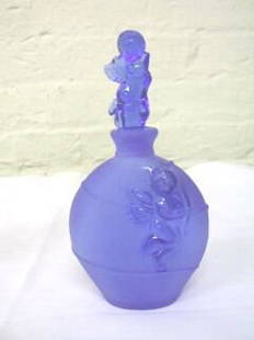 Cobalt Cherub Perfume Bottle Cows Heads.: Cobalt frosted bottle with unfrosted cherub on both sides of base. The stopper is a cobalt cherub figurine. This piece is in very good condition. However, the dauber is not intact. The base has the