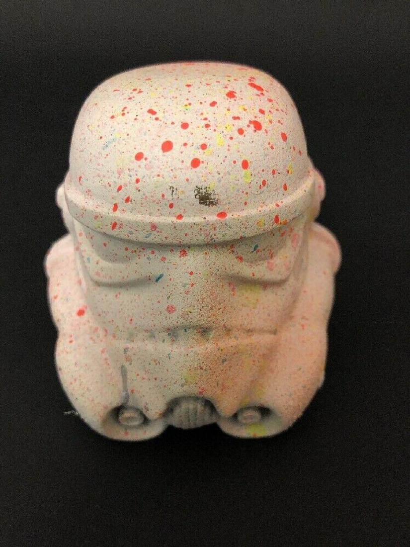 Schoony Storm Trooper Helmet: Litre colobration schoony did years back with artwars featuring the iconic storm trooper helmet and splashing with paint. Signed and number by Schoony. Size 8cm x 8cm x 8cm roughly. Edition 10/50.