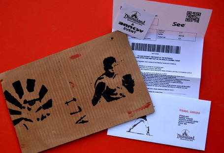 Banksy, Spray Paint Stencil on Cardboard - Original: Banksy, Spray Paint Stencil on Cardboard -Muhammad Ali, Original Dismaland Souvenir, With park entrance.With sticker on the back. With two holes hangingMeasures: 31.5 x 20 cm