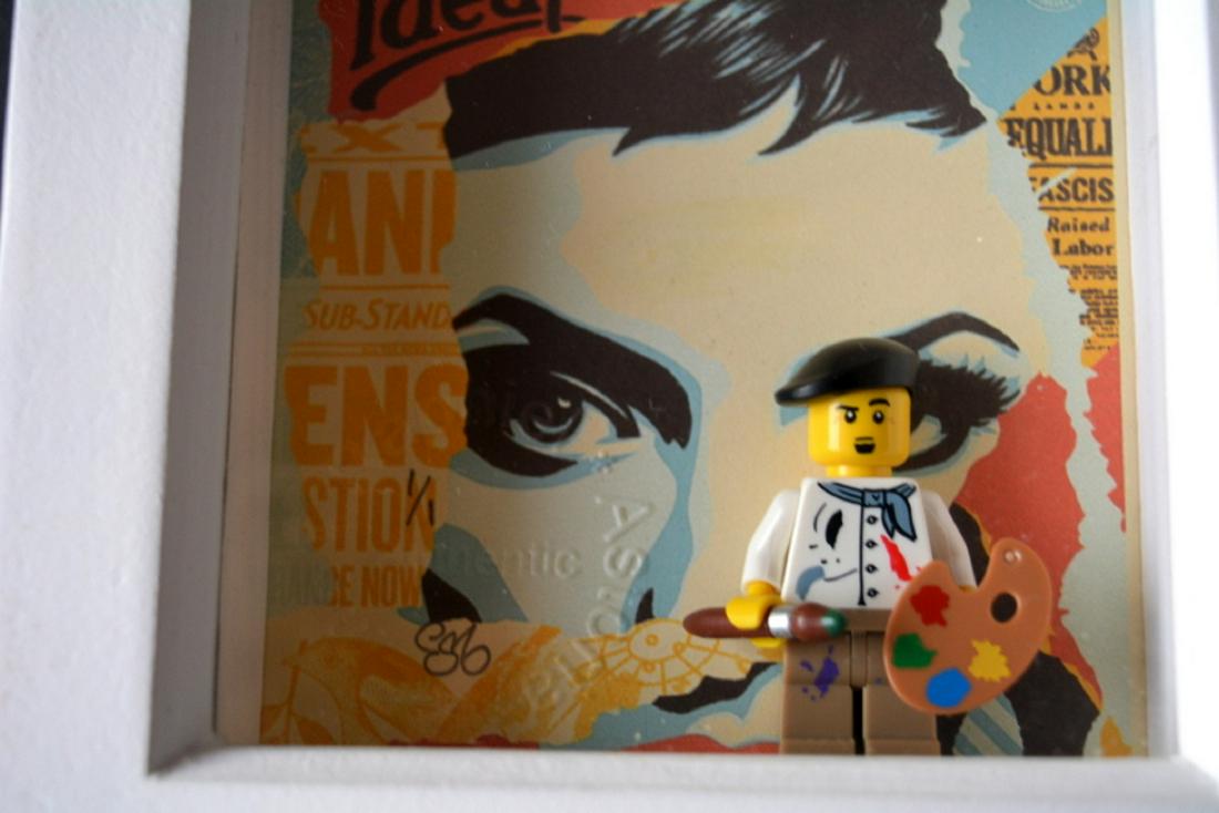 EMO RAPHIEL ASTORIA, ,Giclee print with original Lego: TITLE: SHEPARD FAIREY ARTIST. ARTIST: EMO RAPHIEL ASTORIA. STYLE: Giclee print with original Lego figure. SIGNED: YES. SIZE: h 12.8cm x w 12.8cm. EDITION: 1/1. Issued as mint condition with certificat