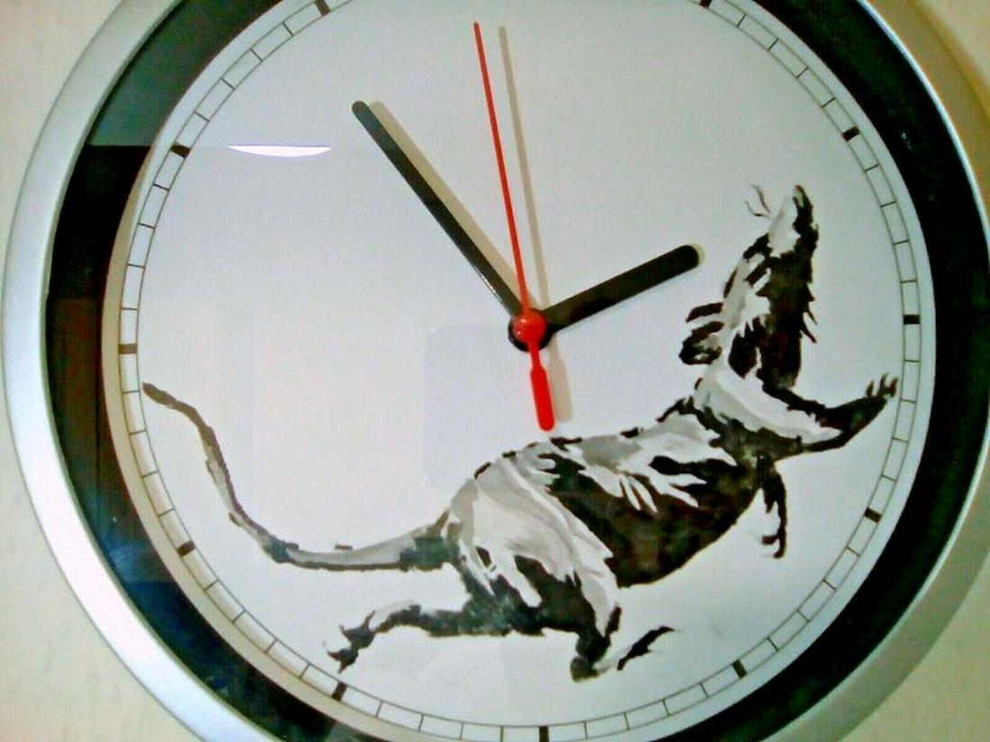 Banksy Running Rat Clock Gross Domestic Product: This is an extraordinary piece for any Banksy fan. Recently, the artist known as Banksy has opened a store in London called 'Gross Domestic Product'. Here he exhibits many of his stunning, thought pro