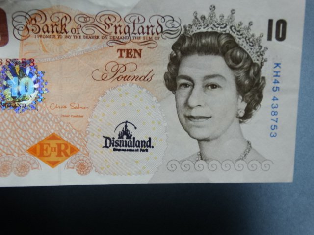 Banksy: Stamped Dismaland on bottom.The note started life as a genuine UK twenty pound note - before becoming a piece of art history so has all the security features including holograms, watermarks, and highl