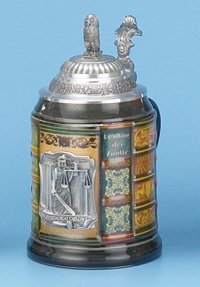 LAWYER BOOK STEIN: Stoneware, raised-relief and transfer decoration. The bookshelf motif of soft muted books serves as the framework for a pewter medallion. On the medallion are the Scales of Justice amidst pillars and