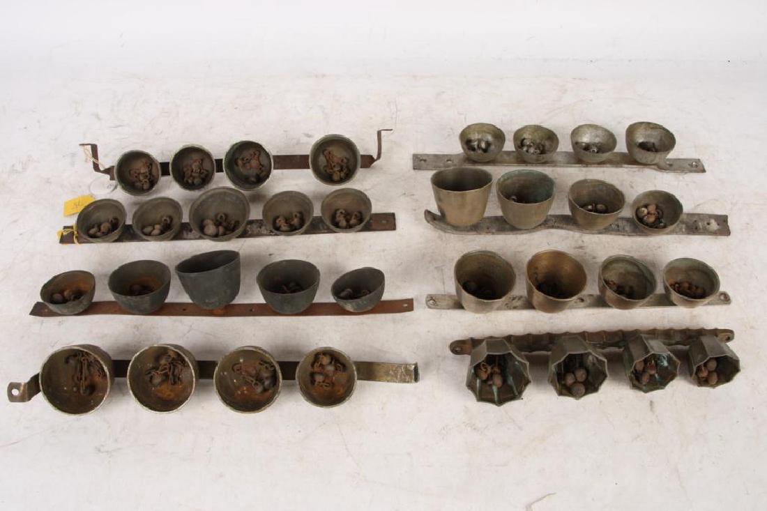 (8) ANTIQUE SHAFT / POLE / ICE CREAM BELLS: (4) graduating bells and (1) with (5). Each with (3) clappers. In brass, nickel and chrome. Some interesting examples here. (1) leather strap.