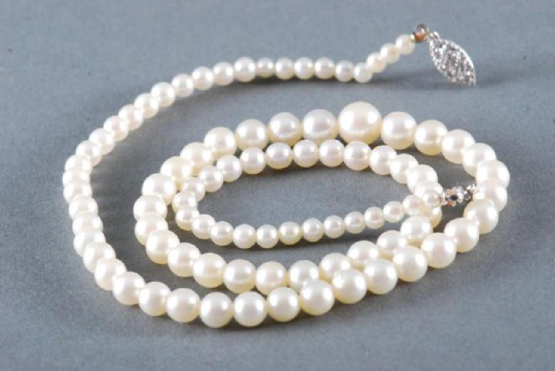 PEARL NECKLACE with 14K WHITE GOLD CLASP: 17 inch strand of graduating pearls.