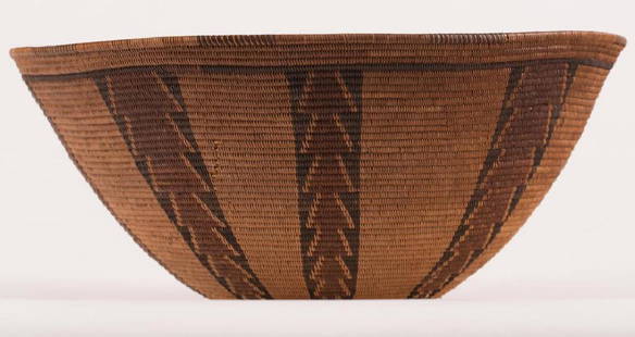 EARLY CALIFORNIA INDIAN BASKET: Possibly Panamint, coil construction with alternating woven colored patterns. 5 1/2 x 13 inches. It is well documented that Andy showered Jon Gould with gifts during their entire relationship. This