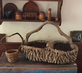 TWO RUSTIC ADIRONDACK BASKETS: Both with twig handles, larger basket measures 18 by 27 by 17 inches It is well documented that Andy showered Jon Gould with gifts during their entire relationship. This sale includes a great quantity