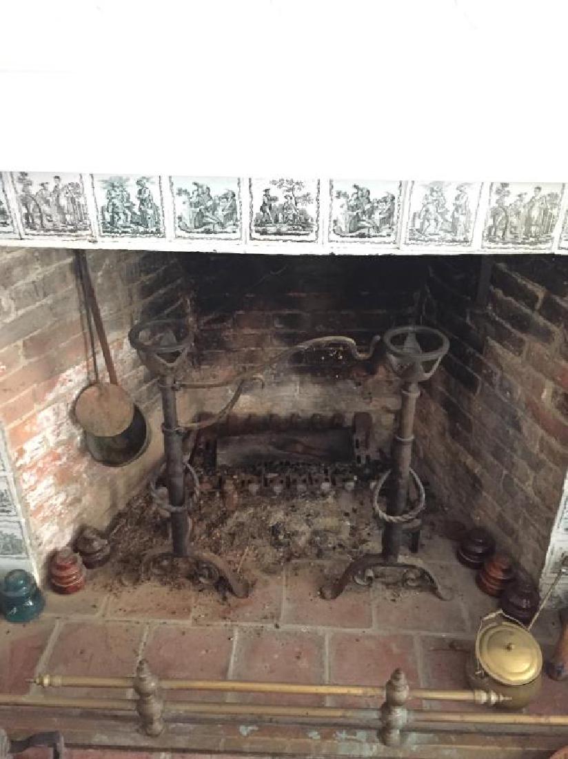 PAIR OF CAST IRON ANDIRONS: Measures 27 by 21 inches