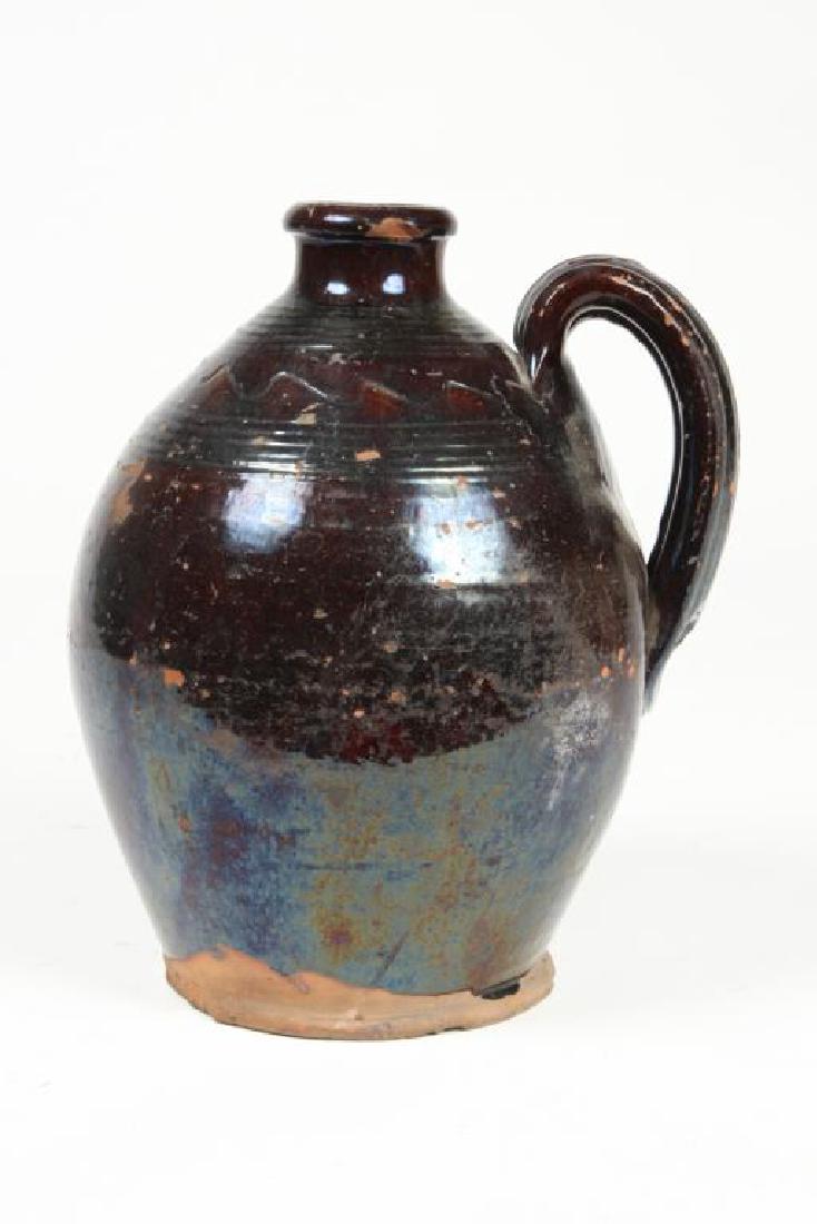 REDWARE OVOID JUG: Brown glaze with incised rings and saw tooth patterns. height 11 inches.