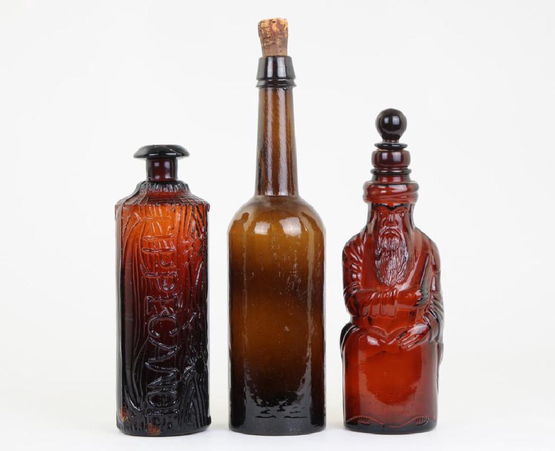 (3) DARK AMBER BLOWN MOLDED BOTTLES: Including: Tippecanoe, Hiram Ricker & Son "Moses Bottle" and a third. 11 1/2 inches (and under)