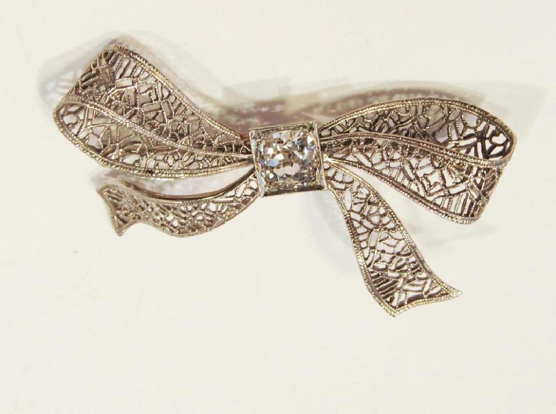 14K WHITE GOLD DIAMOND FILIGREE PIN: Measures 1 5/8 inches wide. 2.4dwt. Old European cut diamond measures approx. 5.3 by 3.1 mm.
