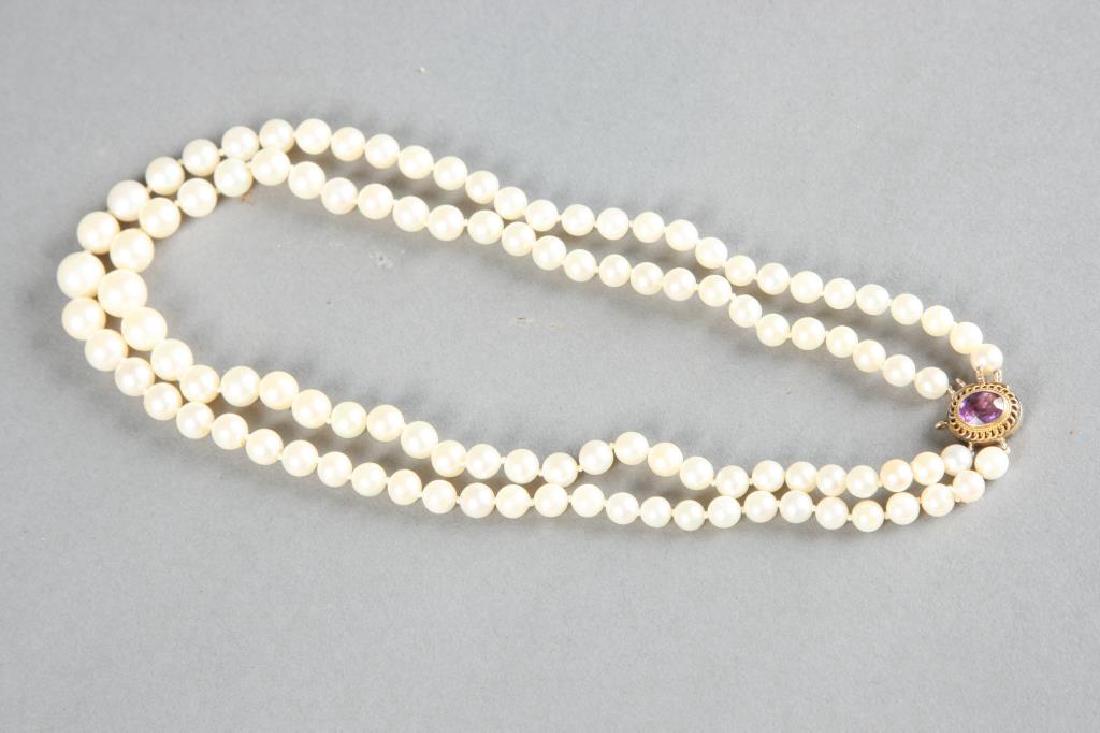 DOUBLE STRAND OF PEARLS with 1.5 CARAT AMETHYST: Double graduating strands of 5.5-9 mm pearls. 8 x 6 mm oval amethyst set in a 14K rose gold setting and clasp. 15 inches.