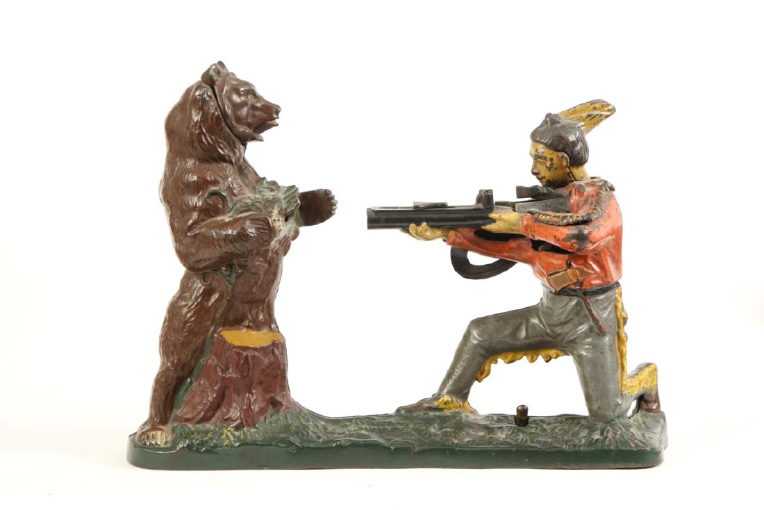 STEVENS CO "BEAR HUNT" MECHANICAL BANK: Cast iron bank. Base stamped "PAT PEND. G" Coin slot stamped "PAT FEB 2 1875". Place coin in rifle barrel, press lever, Indian shoots coin into bear. 7 3/4" x 10 1/2" x 2 3/4"
