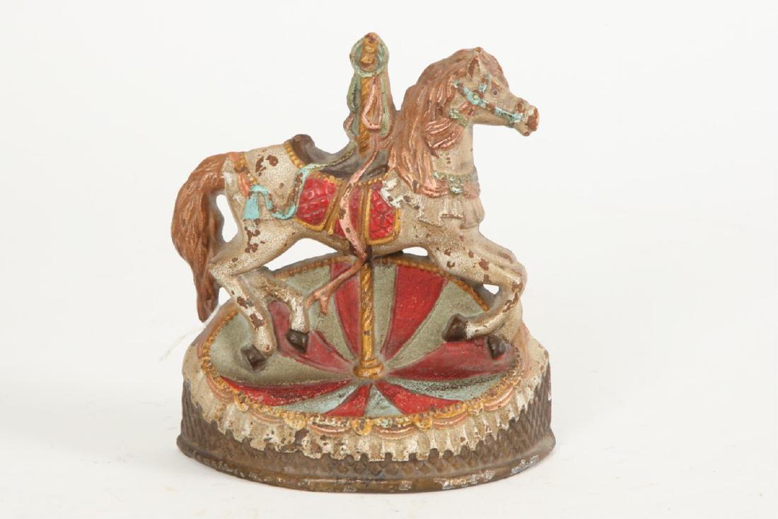 CAST IRON CAROUSEL DOORSTOP: Unmarked. 7 inches