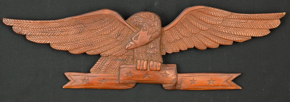 CARVED EAGLE WITH BANNER: 20Th Century primitive carving. 34 3/4 x 10 1/2 x 1 1/2 inches