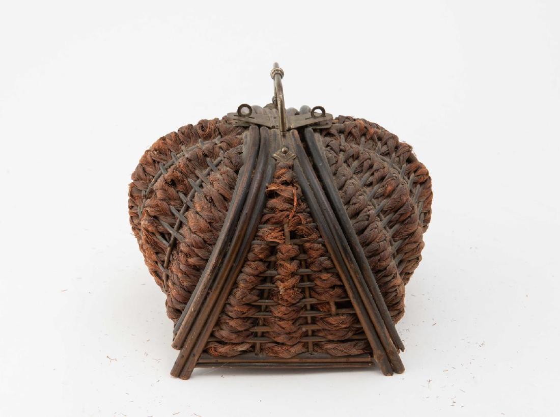 VICTORIAN WOVEN STRAW POCKETBOOK: Ribbed melon shaped with wooden frame. On small wood legs. Brass swing handle and hasp. Tufted red velvet interior. Remnants of paper label on base. 8 1/2" x 9"