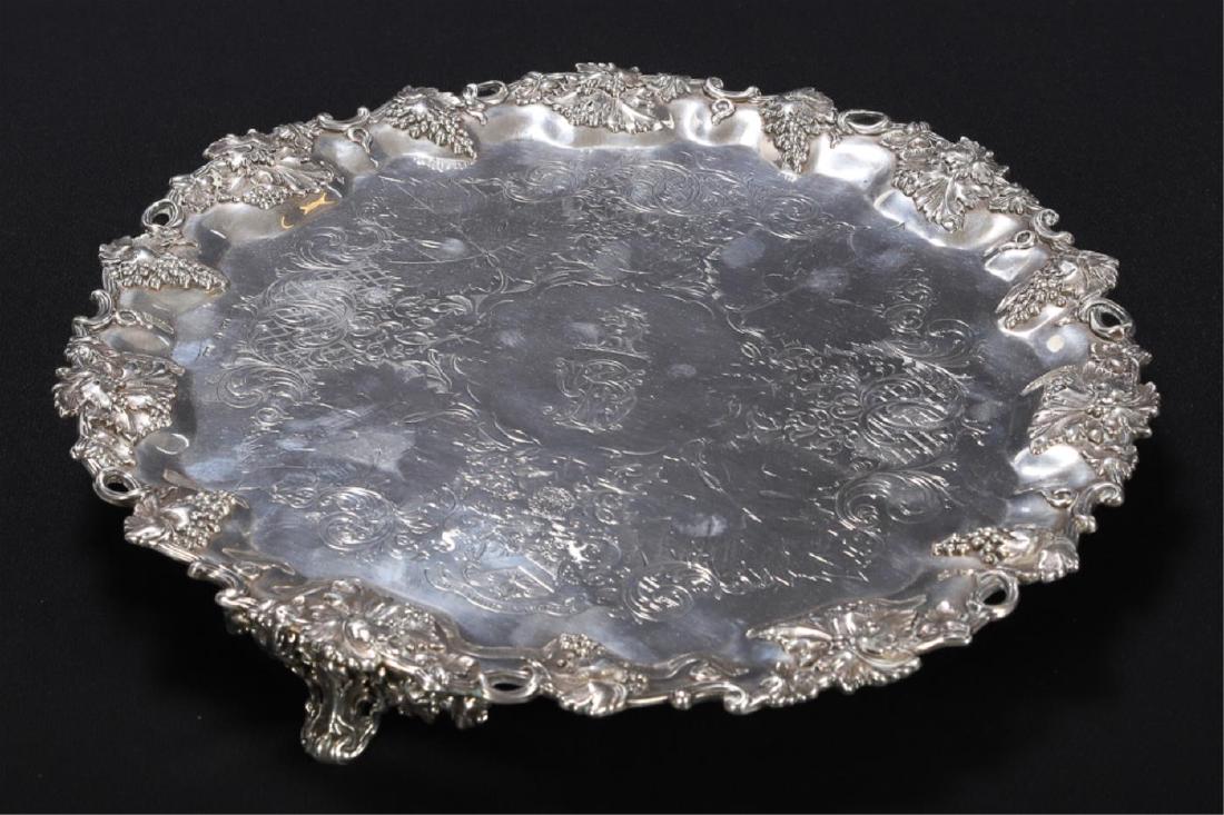 E.H. PARKIN STERLING SILVER ARMORIAL SALVER: Rim shaped and pierced with raised grapevine. Well engraved with Sewell Family Coat of Arm, leaves, scrolls lattice work, and latin proverb "Non Nobis Nascimur". Raised on (3) scrolled feet with conti