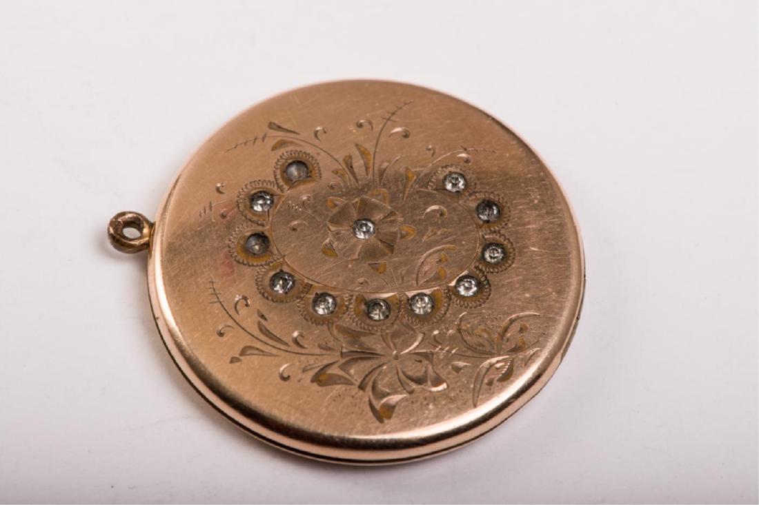 RBM ATRICE GOLD FILLED LOCKET: Engraved "C" and brightcut with floral motif, set with rhinestones. 1 1/2 inches.