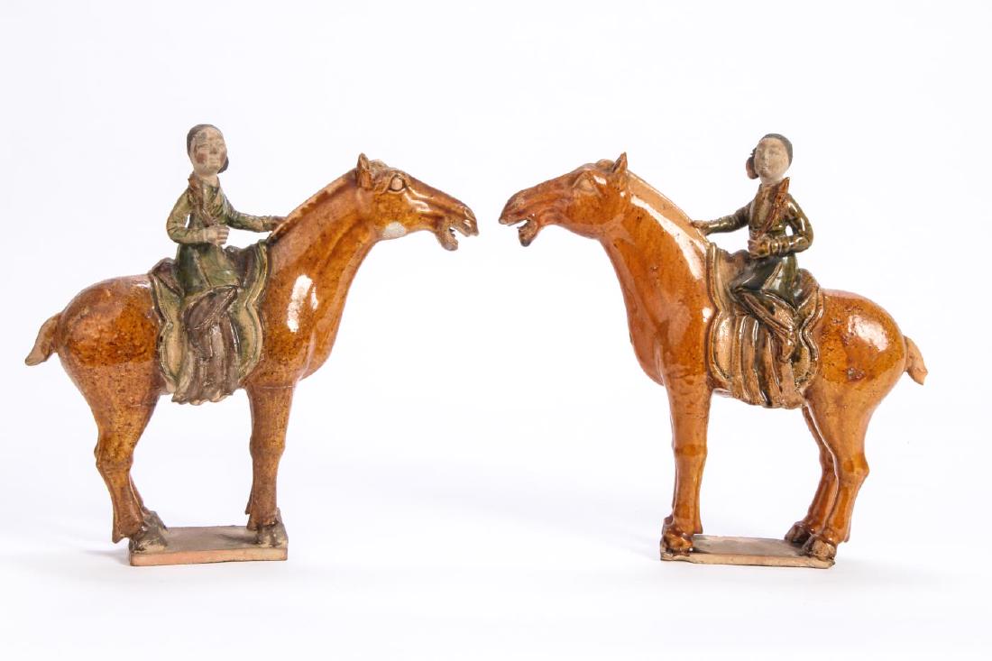 EARLY PAIR OF CHINESE CERAMIC FIGURINES: Depicting women on horseback. glazed and dyed earthenware. 8 1/2 x 9 inches.