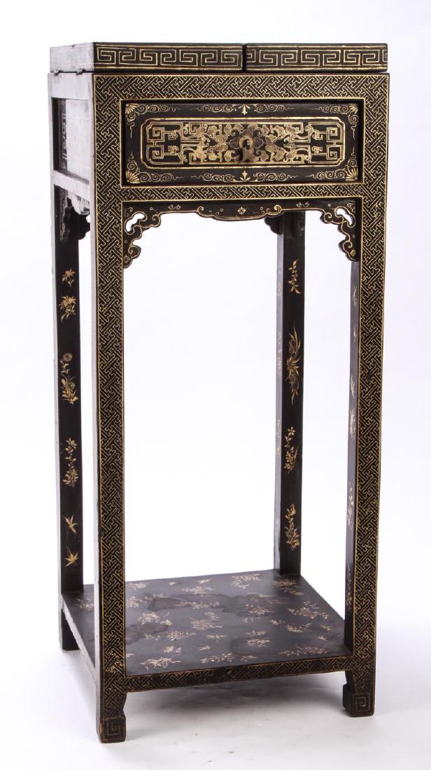 CHINESE LACQUERED DRESSING STAND with MIRROR: Black lacquered stand. Top gilt and paint decorated with landscape that opens to a hinged mirror. 32 x 12 1/2 x 13 1/2 inches.