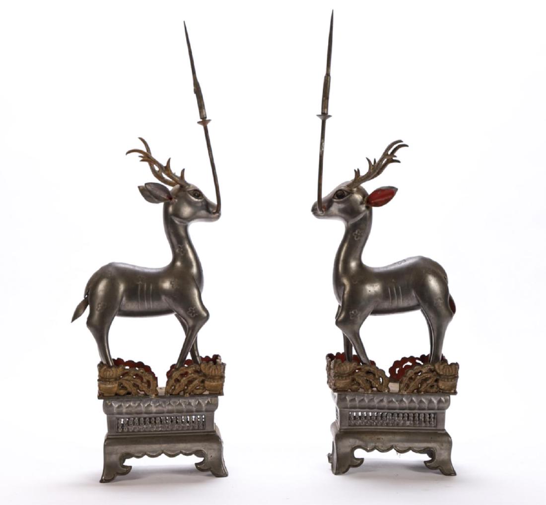 PAIR OF CHINESE PEWTER DEER-FORM CANDLE STICKS: Engraved and painted deer on plinths hold pricket spears in their mouths. 18 1/2 inches
