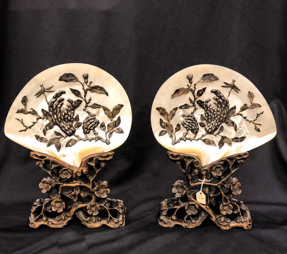 PAIR OF ABALONE SHELLS mounted with SILVER: Prunus boughs and dragonflies. unsigned. 7 1/2 x 9 inches (each). Together with floral carved wooden stands. 12 inches (overall)