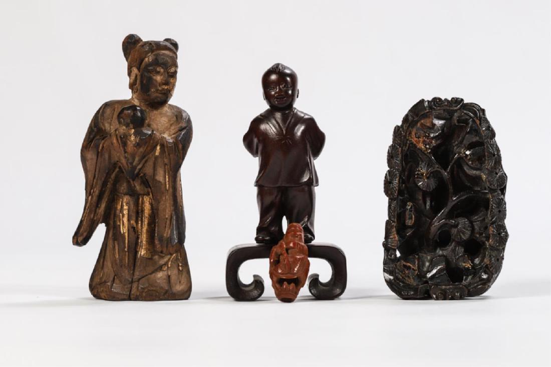(4) ASIAN FIGURAL CARVINGS: Including: Chinese gilt carving of an immortal, Japanese boy with glass eyes on stand, elaborately carved stand with stylized tree and a miniature figure. 4 inches (and under)