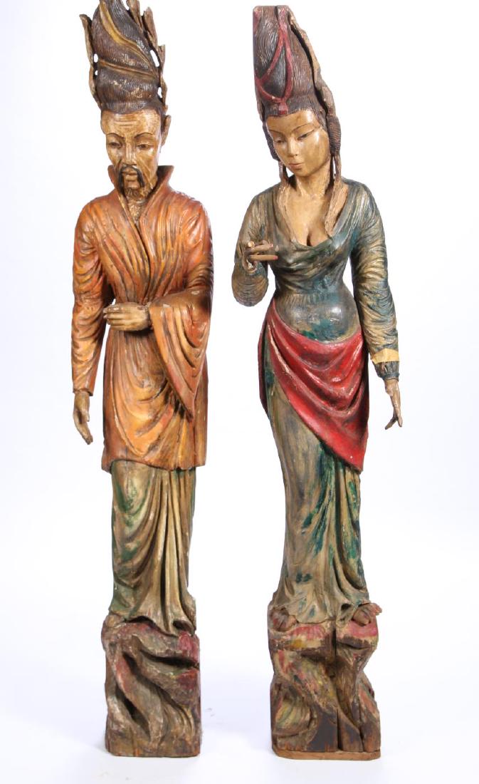 PAIR SOUTH EAST ASIAN CARVED AND PAINTED STATUES: (19th c) Statues of a Traditional Southeast Asian couple. carved from (2) pieces of laminated hardwood. 77 inches (and under)