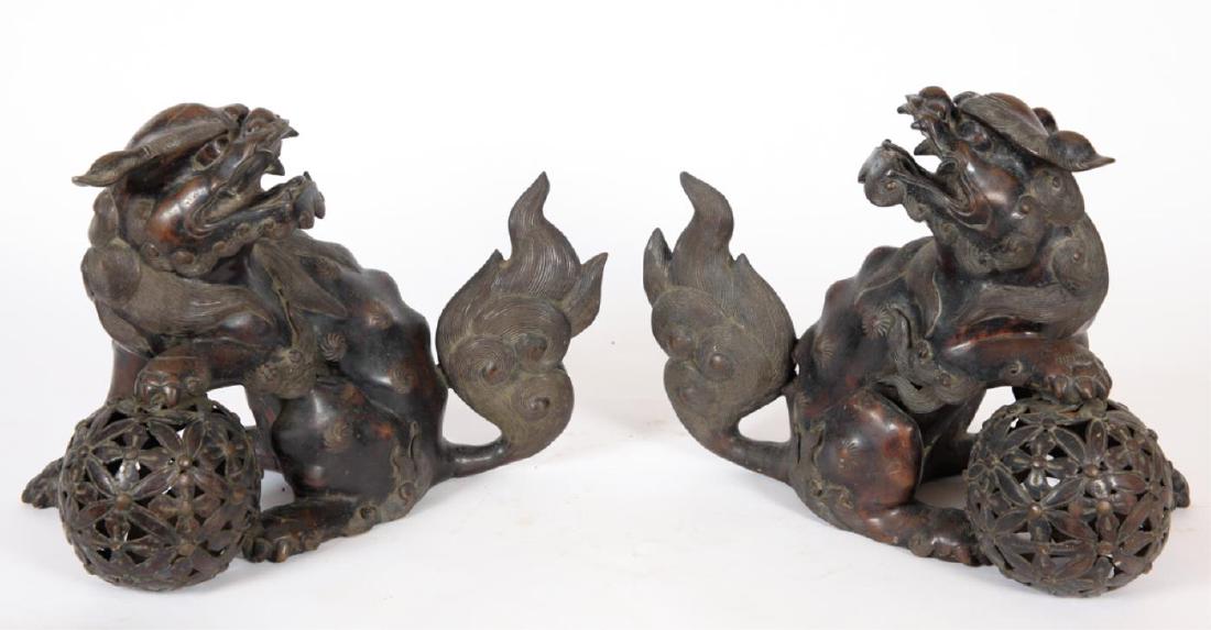 PAIR OF FINELY CAST BRONZE CHINESE FOO DOGS: (Or temple dogs) Finely cast details including on their mane and tail. cast and weighted bronze. unsigned. 12 x 15 x 10 inches.
