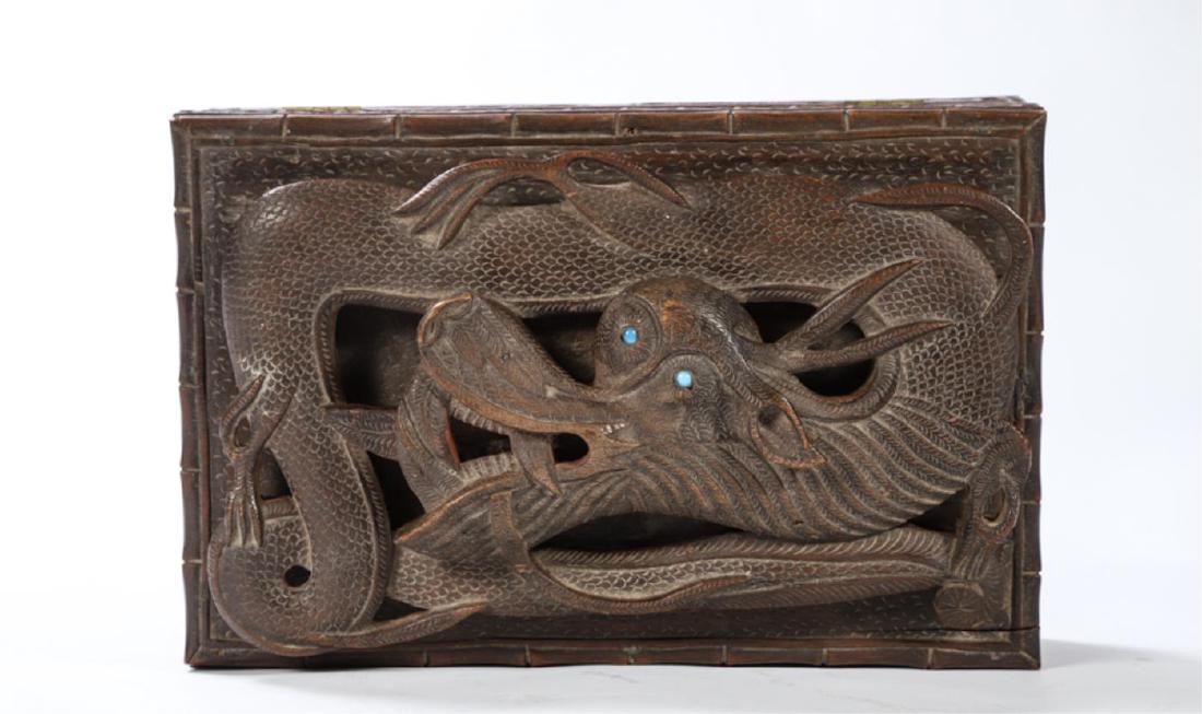 JAPANESE CAMPHOR WOOD BOX CARVED with a DRAGON: Deep relief and eyes set with turquoise stones. Faux bamboo rim with repeating floral design on all (4) sides. Interior divided into (3) sections. 5 x 11 x 7 1/4 inches