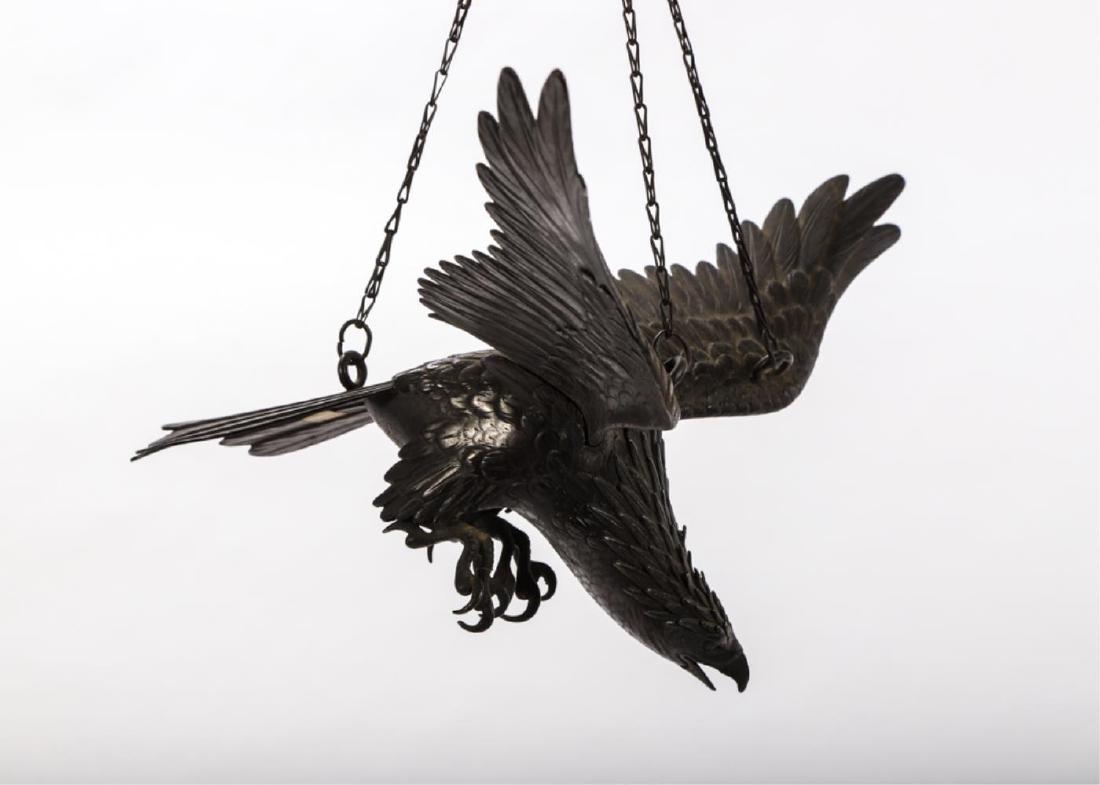JAPANESE MEIJI BRONZE EAGLE SUSPENDED IN FLIGHT: Finely engraved wings and tail feathers cast separately and assembled. (3) Rings and chains to be suspended. 10 x 24 x 11 inches.
