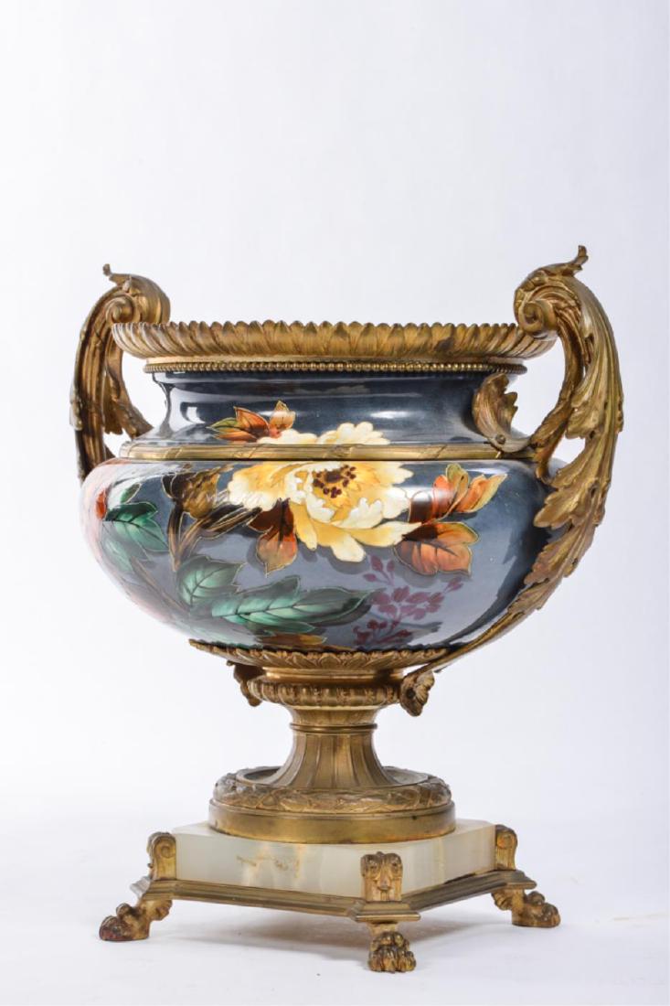 ORMOLU MOUNTED URN in the MANNER of THEODORE DECK: Faux cloisonne floral motif outline in raised gold enamel. Mounted with scrolled acanthus leaf handles, repeating leaf-from rim, onyx base and lion paw feet. 15 x 15 x 11 inches. unmarked (not removed
