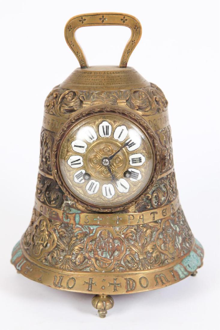 JAPY FRERES BELL-FORM PRESENTATION MANTLE CLOCK: Bronze case cast in low relief with figures, scrolls and acanthus leaves. (3) inch porcelain dial with Roman numerals and striking movement. 11 inches. Presented to G.J. Clarkson from the Diocesan Ass