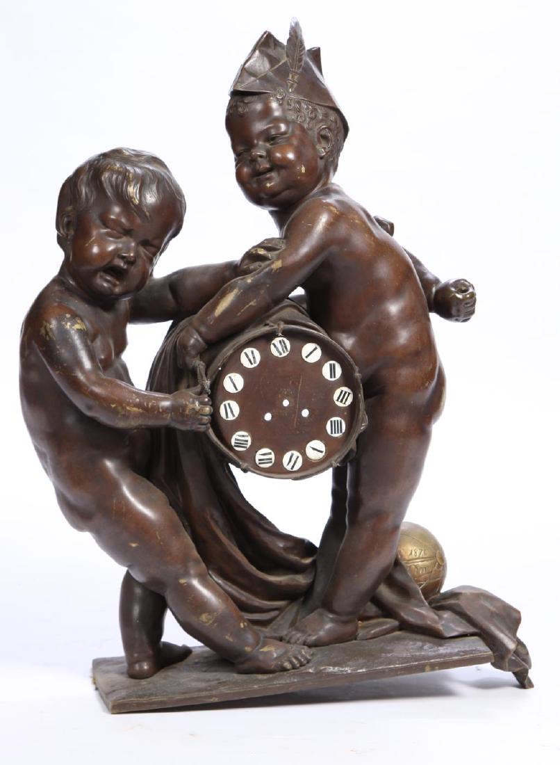 LARGE (19th c) NOVELTY FIGURAL BRONZE CLOCK CASE: Fragment of a "Young boy smiles as the drum-form clock advances while the second cannot hold back time " bronze with traces of gilding. signed 1876 Anno. 32 x 24 x 9 inches.