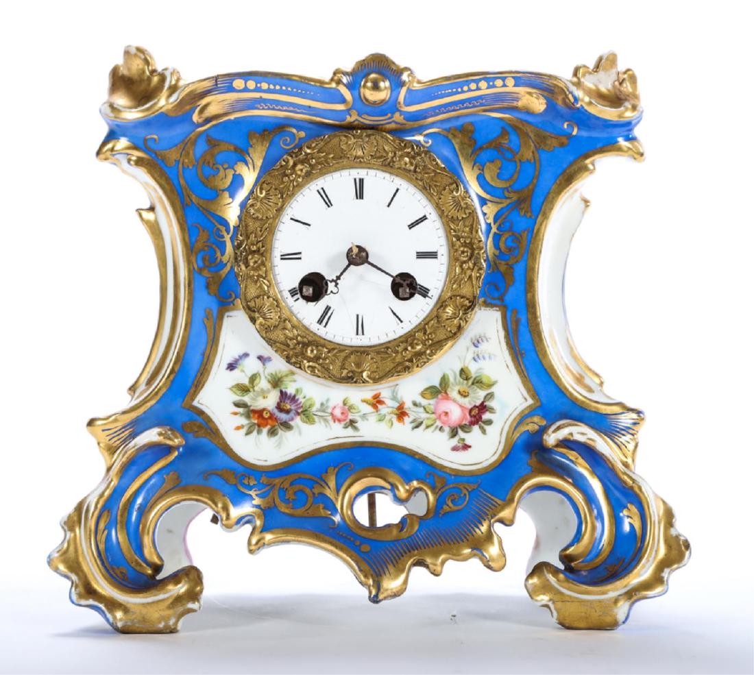 FRENCH PORCELAIN SHELF CLOCK: 2 3/4 inch porcelain dial with chiming movement, gilt bronze bezel cast with shells and flowers. Porcelain case is hand painted with flowers and gilt highlights. 9 x 9 1/2 x 4 inches.