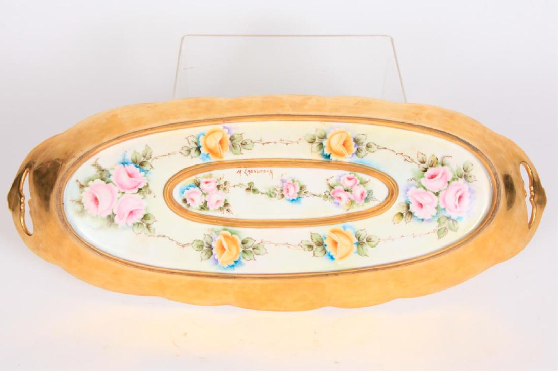 GILT CHINOISERIE-THEMED PORCELAIN PLATTER: Etched with a phoenix, the back hand painted with roses signed M. Lashbrook. 24 x 10 inches.