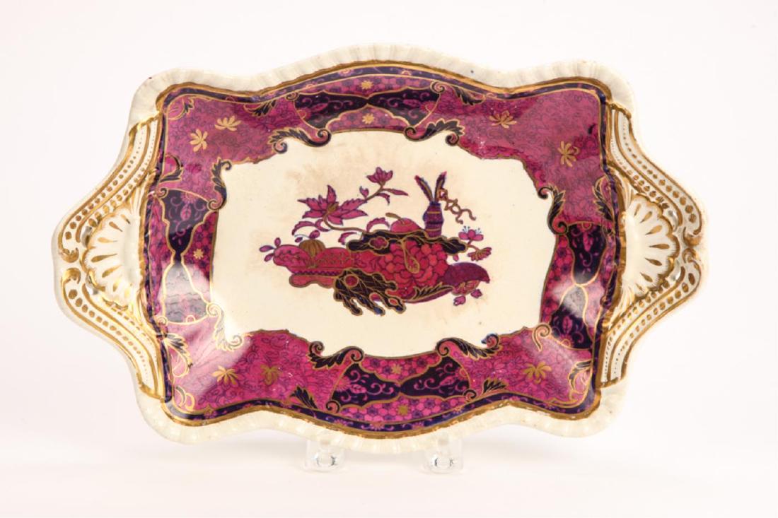 SPODE “IMPERIAL” BONE CHINA TRAY: Pierced and embossed shell handles highlighted in gold. Well is decorated with a plum and raspberry floral motif also highlighted in gold. 8 x 12 inches.