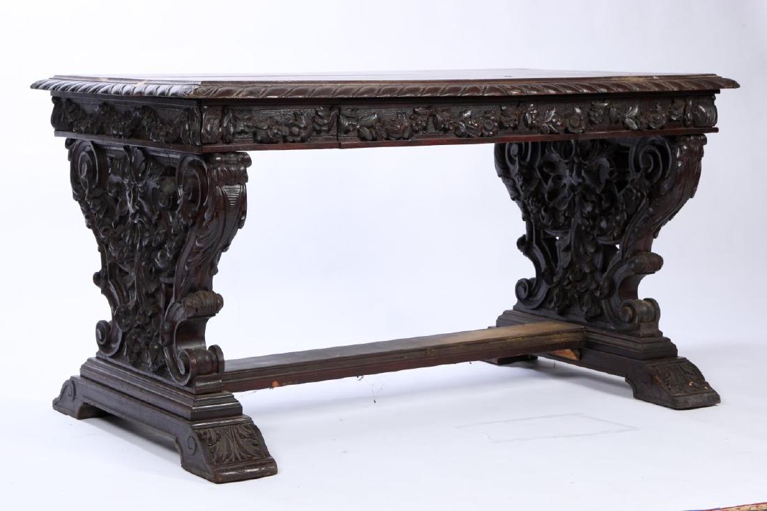 HIGHLY CARVED ITALIAN RENAISSANCE ONE-DRAWER DESK: Molded and gadrooned top. Apron with single draw is deeply carved with floral swags and is supported by (2) similarly carved and scrolled pedestal-ends secured by a molded H stretcher and raised on ac