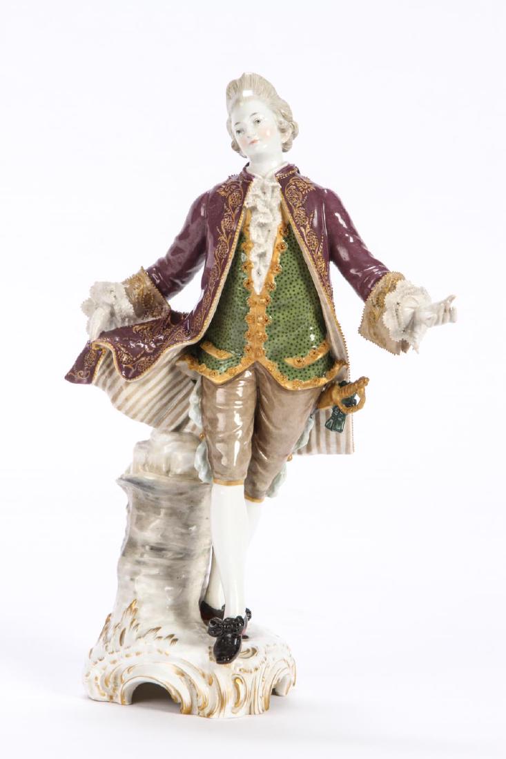 KPM PORCELAIN FIGURINE OF AN (18th c) GENTLEMAN: In courting attire and complete with sword and gilt highlights. signed and numbered 140/210. 9 1/2 inches.