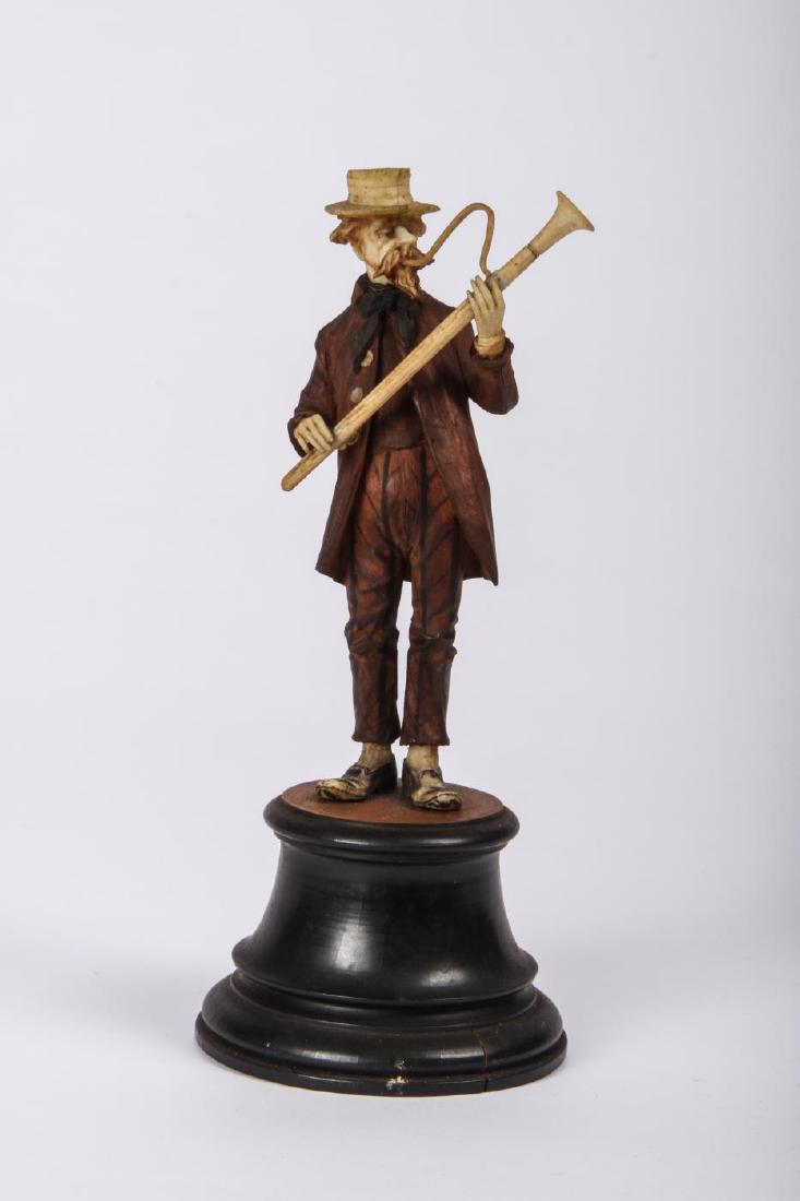 CARVED WOOD FIGURINE OF AN OBOIST: Unsigned. 6 inches (including plinth)