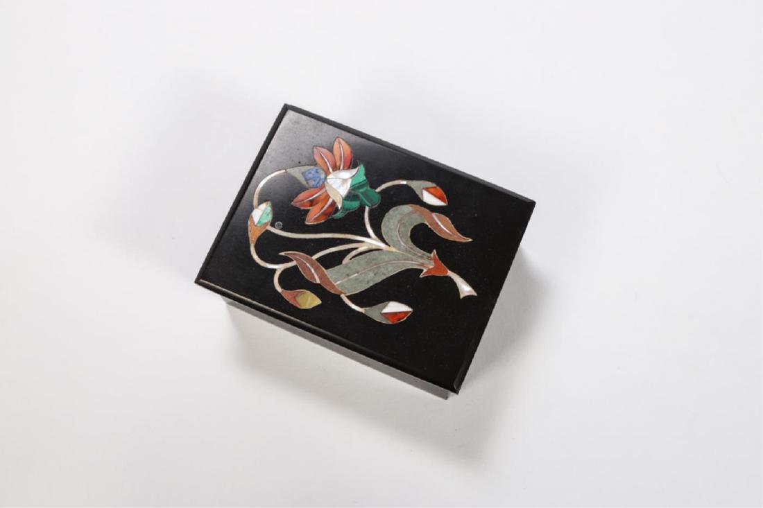 BLACK MARBLE PIETRA DURA BOX: Lid inlaid with floral motif comprised of hard stone an mother of pearl. 1 1/2 x 4 x 3 inches.