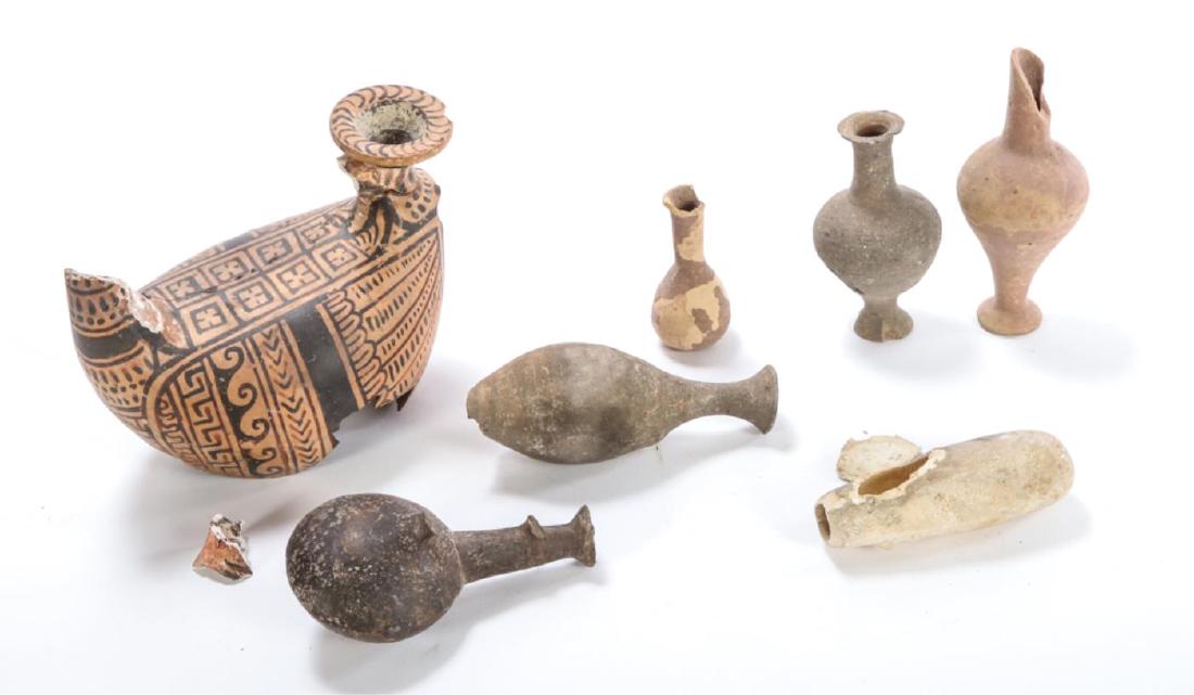 TERRACOTTA ASKOS VESSEL FRAGMENT & (6) BOTTLES: Askos decorated with geometric designs. 5 1/2 x 7 1/2 x 5 1/2 inches. (6) additional stoneware and redware vessels including Taormina measure 6 inches (and under)
