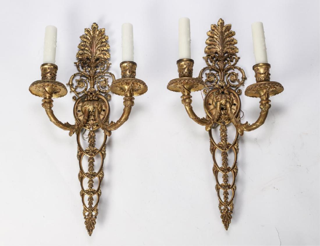 PAIR OF GILT BRONZE (2) LIGHT WALL SCONCES: Cast with a foliated spray, scrolled arms wrapped with laurel boughs, egg and dart bobeches, ribbon and swag sockets and interlocking descending bell flowers. 19 1/2 inches