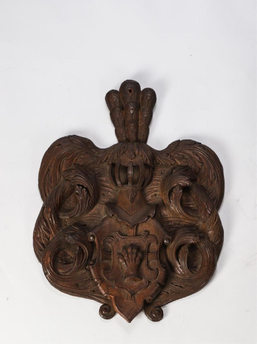 (18th / 19th c) COAT OF ARMS: Carved wood. Sovereign helm, scrolled mantling and unusual paw shield. 18 x 13 inches.