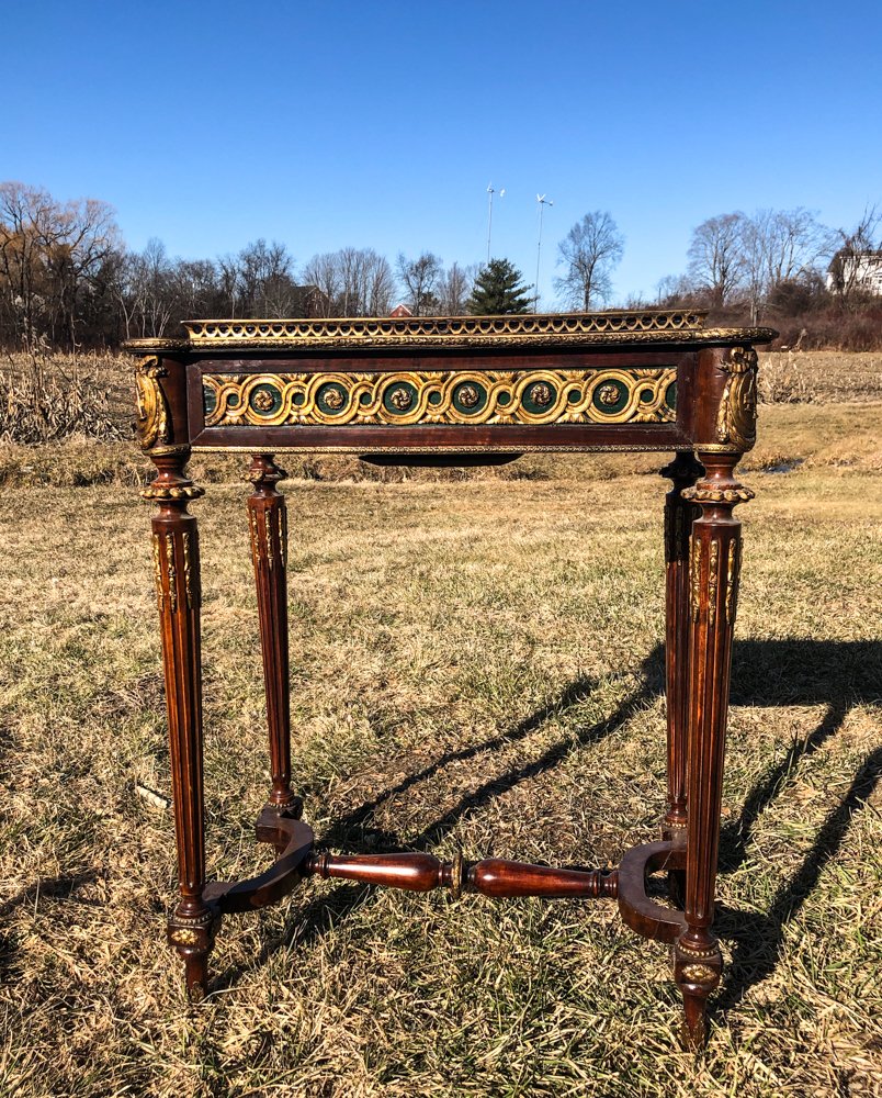 FRENCH JARDINIERE STAND W/ ORMOLU AND INLAY: Leather writing surface with floral and string inlay decorated top. Features removable center, exposing a zinc lined interior. Ormolu and green painted frieze with floral and musical motif atop fluted
