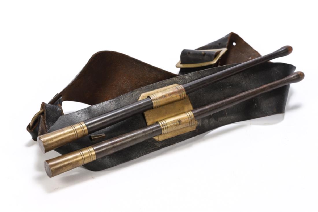 PAIR OF CIVIL WAR DRUM STICKS AND CARRIER: Brass ends with matching holder mounted to leather strap, drum stick length 16 inches