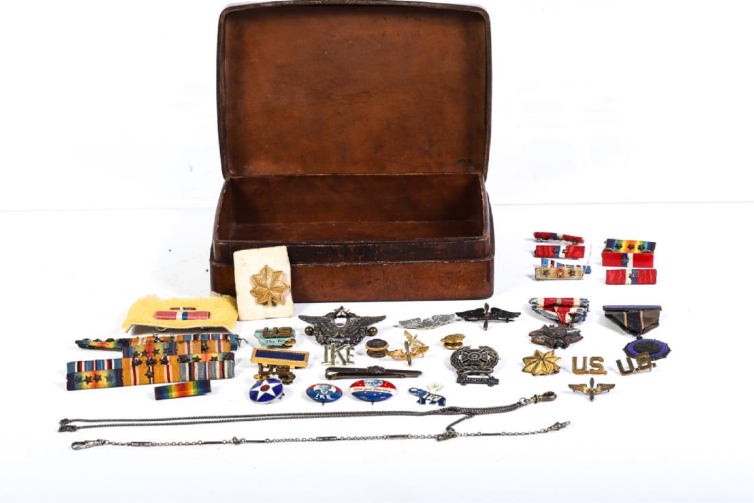 PILOT FRANCE Q. WILSON WWI-WWII AVIATION MATERIAL: Including: WWI Aviator's medal presented by the French Government, (1) WWI Pilot's Wings, (1) WWI Wings, (1) lapel pin, (2) WWI Pilot's Wings and lapel pin, Pistol medal, (2) Major's Oak Leaves, and a