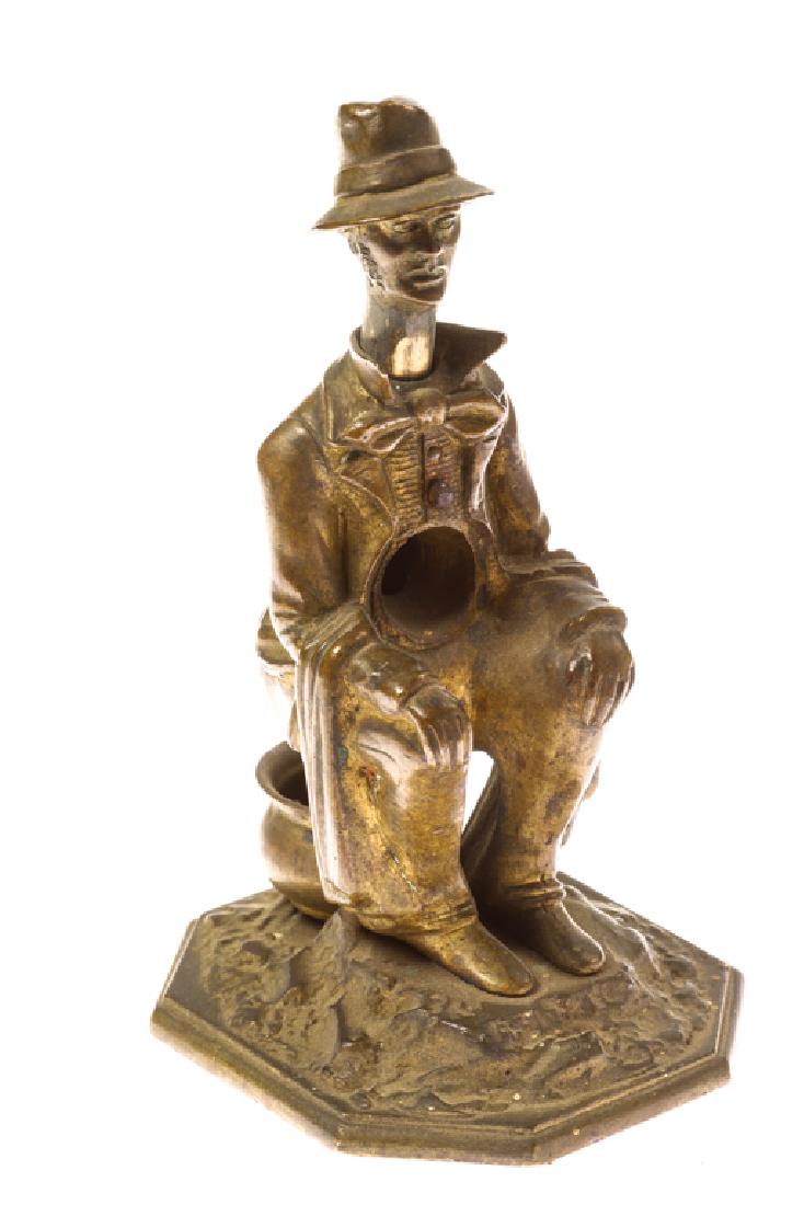 BRONZE FIGURAL CIGAR CUTTER: Man squats above a chamber pot. Push on hat to cut cigar and the tip falls into pot. unmarked. 5 inches.