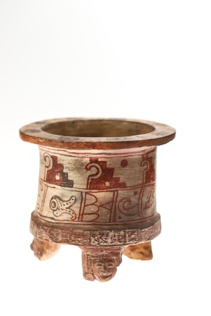 MAYAN DECORATED (3) FOOTED CERAMIC VESSEL: Hand painted with geometric and figural motifs. Head sculpted figural feet. 5 1/2 x 6 1/4 inches.