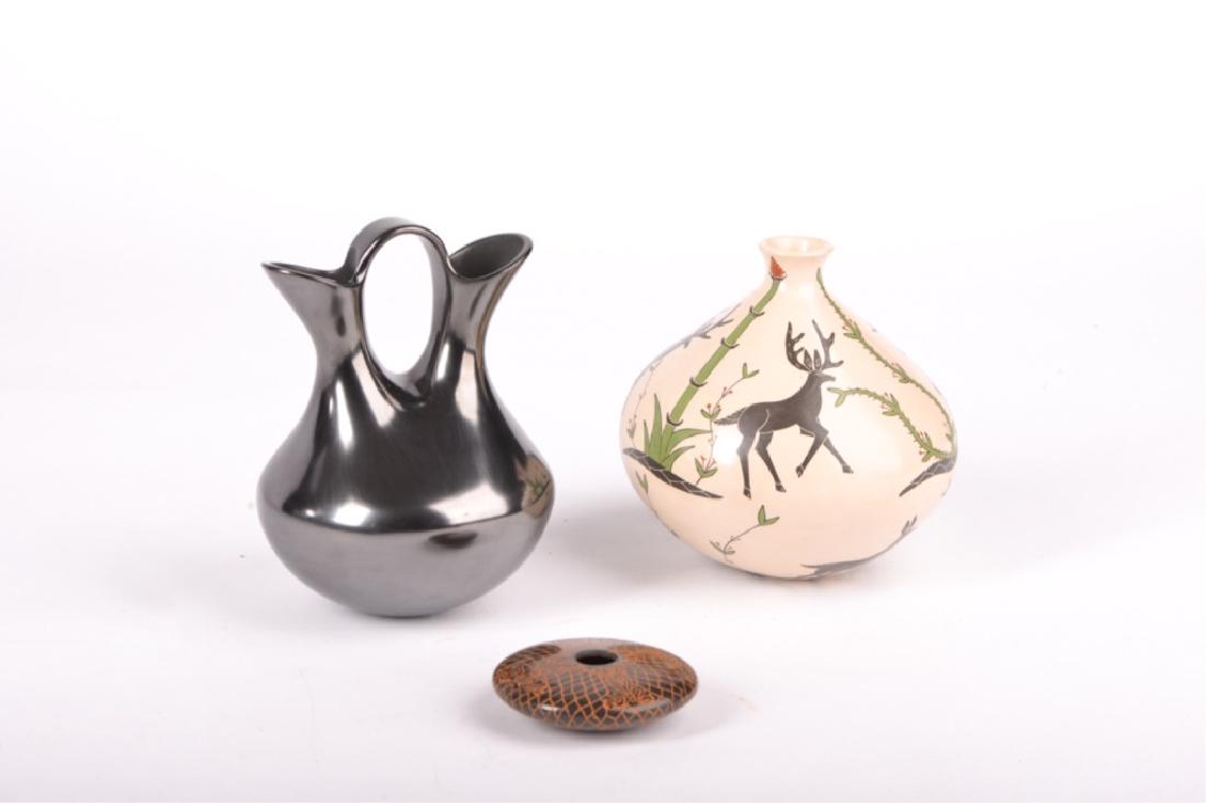 GROUP OF THREE MATA ORTIZ POTTERY VESSELS: Martin Olivos double-necked wedding vase, 7 inches high; Uriel Lopez stag-decorated vessel, 6 inches high; and a celia Ortega disc vase, 3.5 inches diameter